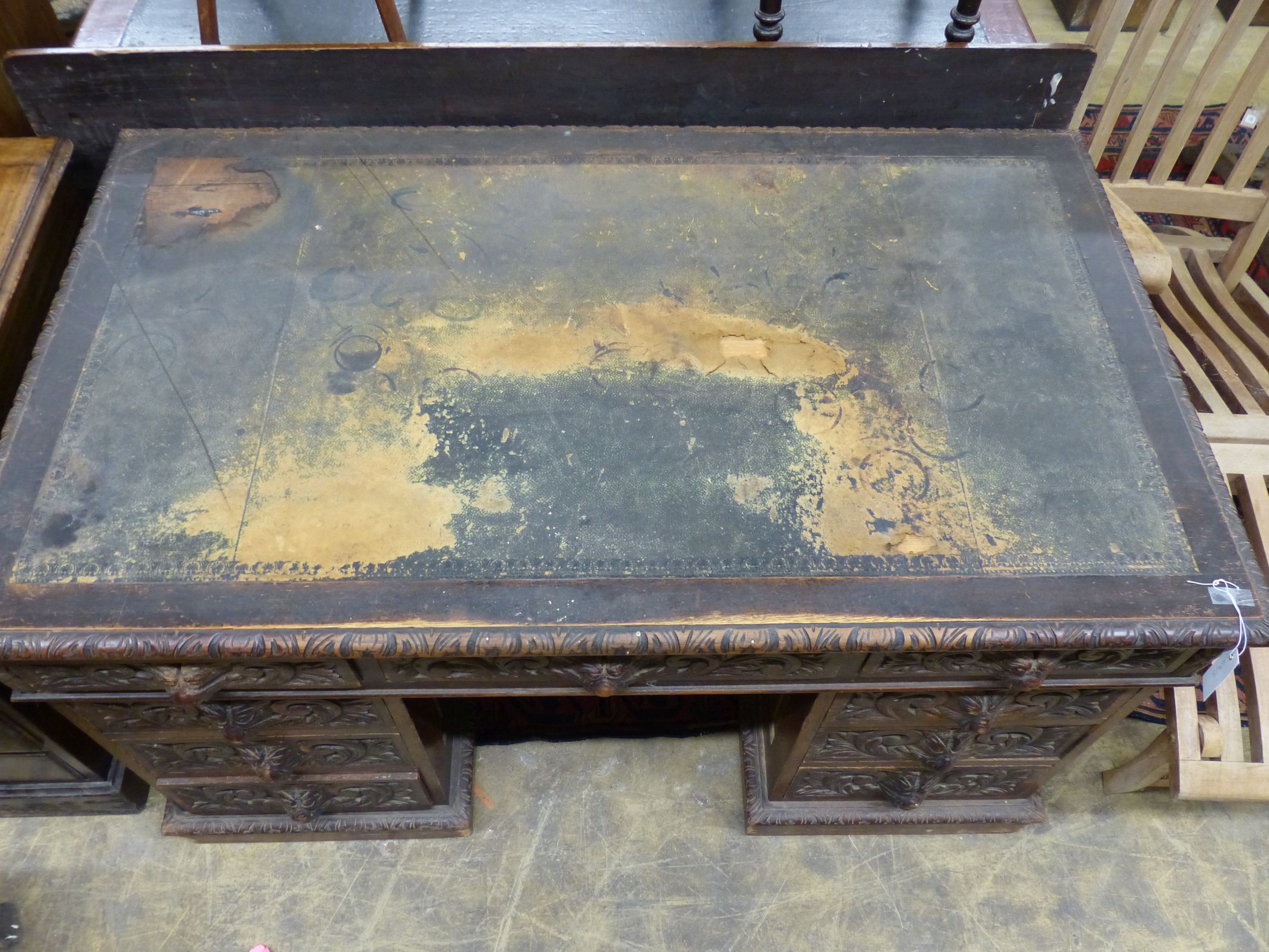 A late Victorian carved oak pedestal desk, length 138cm